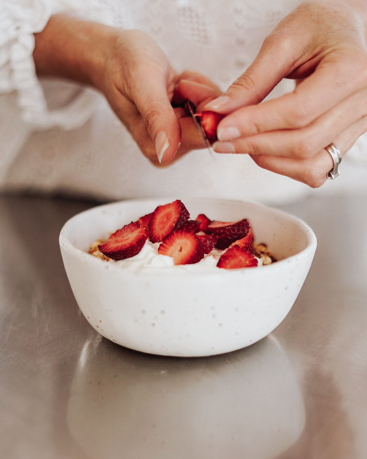 Chopping strawberries into her Winterwares handmade Lagom bowl.