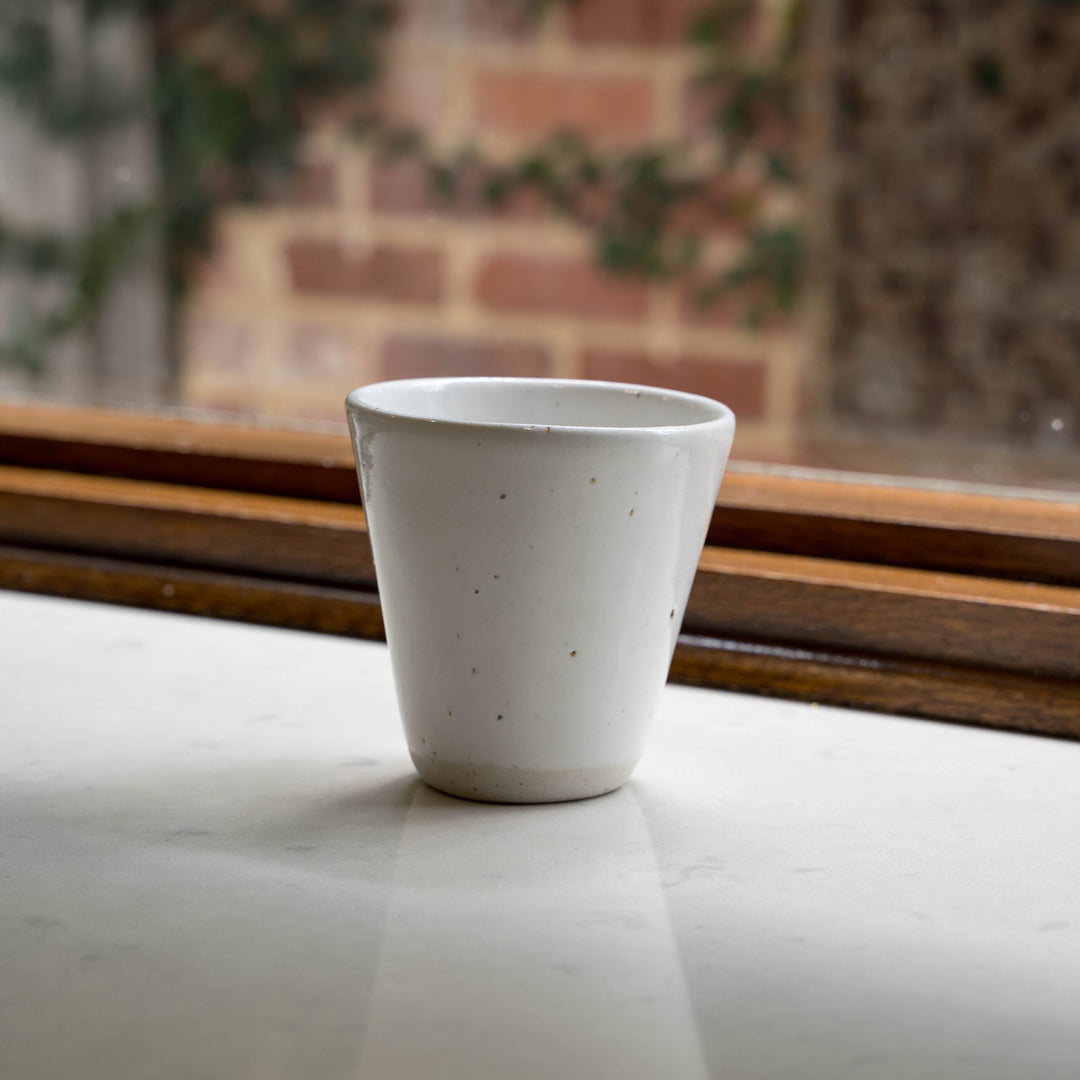 Speckled white ceramic latte cup